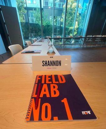 Lab signage in the venue reading someone has to build what is next